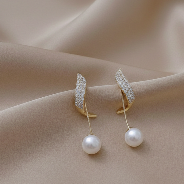 Pair of gold earrings with pearl drops