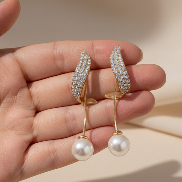 Pair of gold earrings with pearl drops