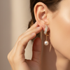 Pair of gold earrings with pearl drops
