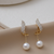 Pair of gold earrings with pearl drops