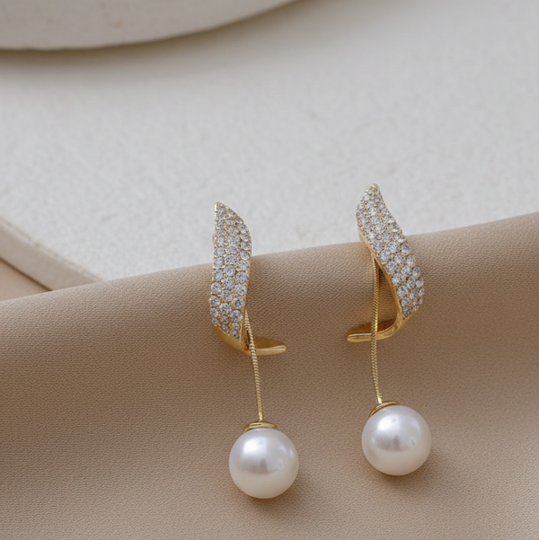 Pair of gold earrings with pearl drops